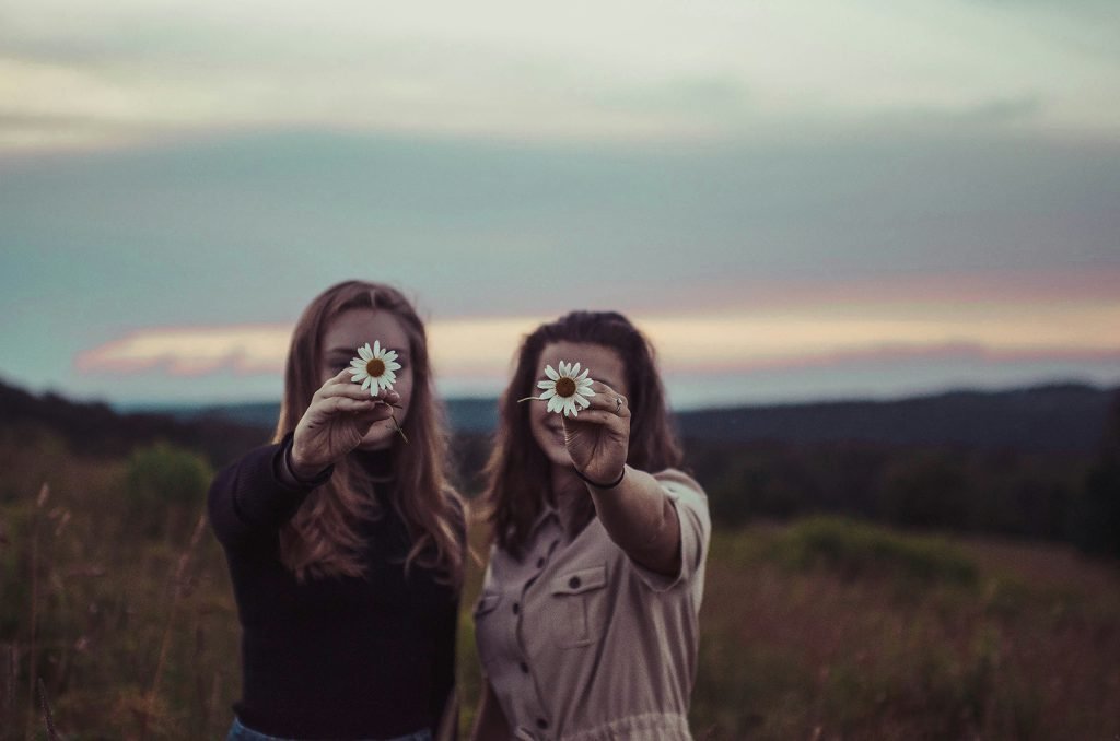 two women with estrogen dominance holding flowers