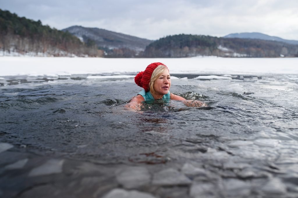 woman swimming in frozen lake