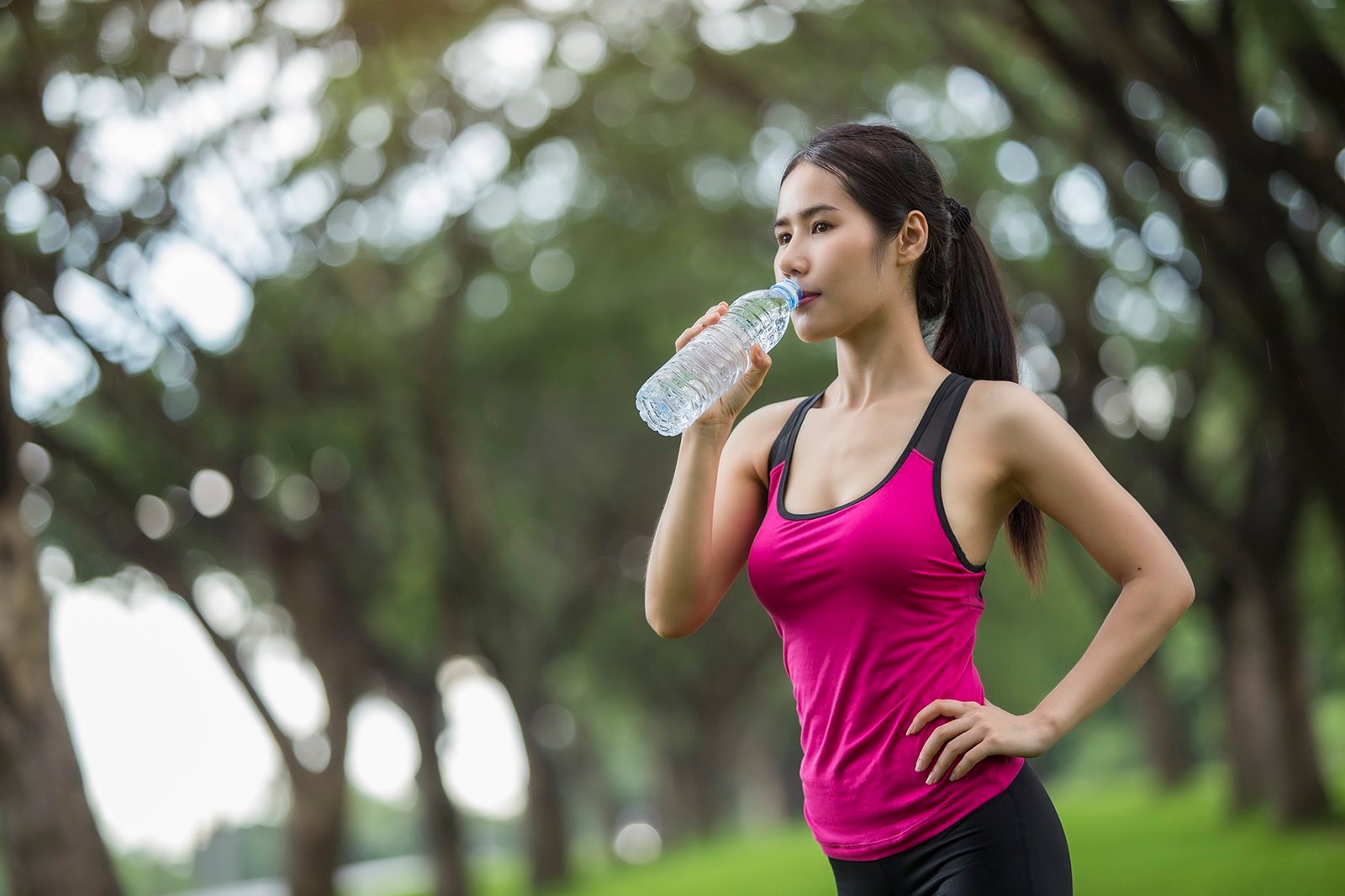 woman drinking water when exercising