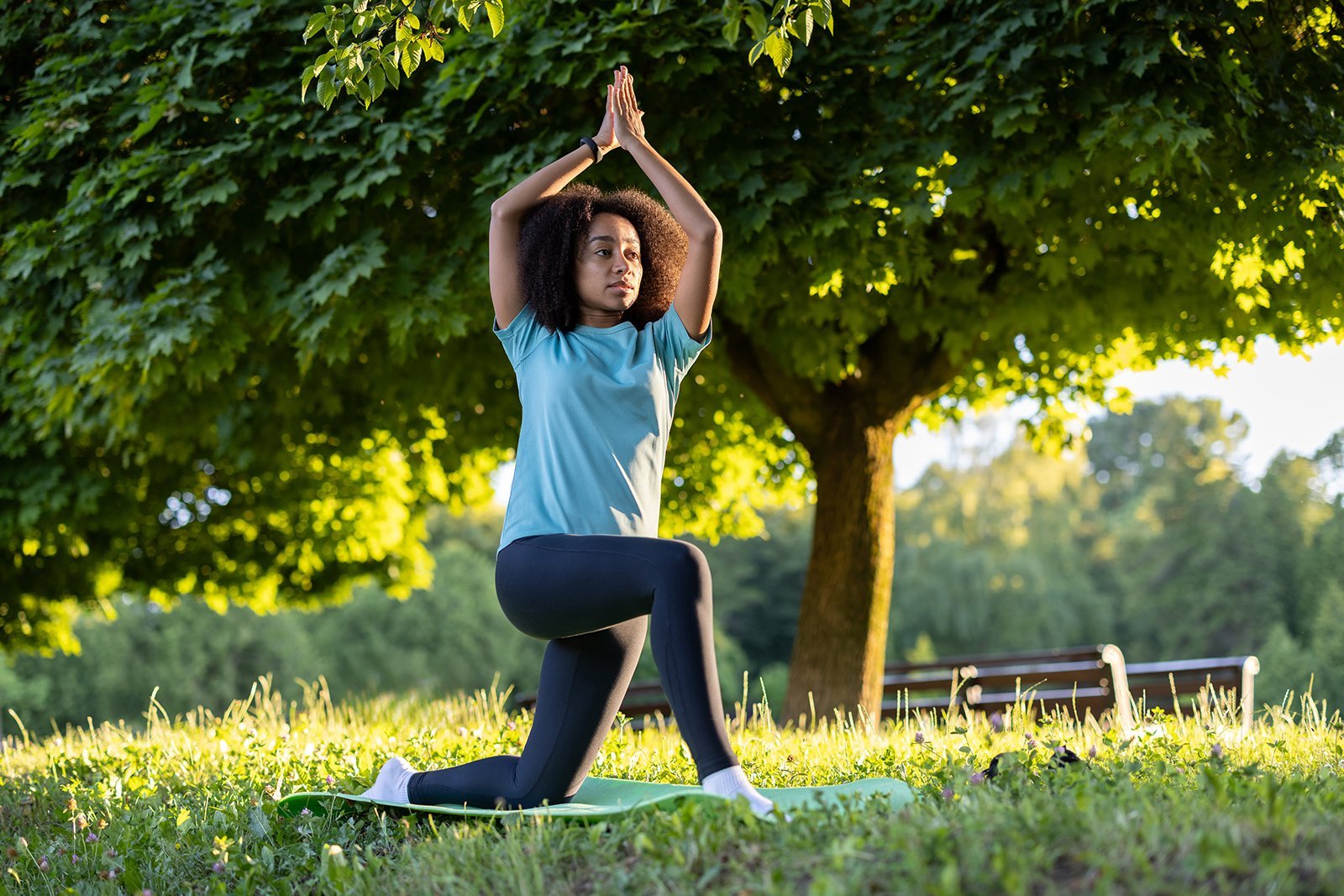 Woman doing yoga outside in park