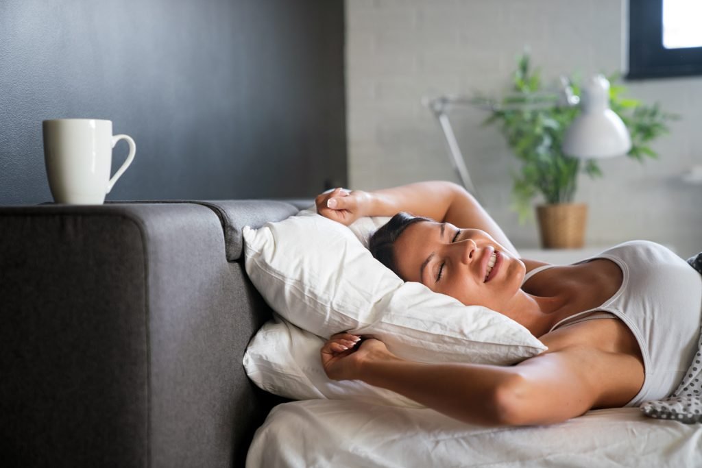woman waking up after getting quality sleep