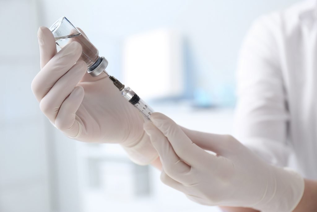 doctor with hormone injection for bioidentical hormone therapy