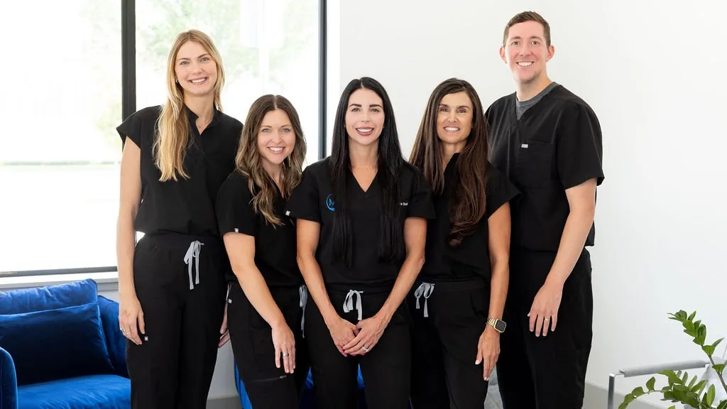 Five Modern Endocrine clinicians in black scrubs inside the clinic